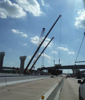 A bridge being constructed over the freeway.