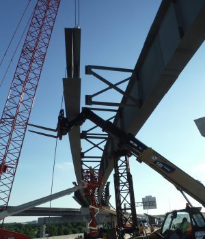 A crane is lifting the beams of a bridge.