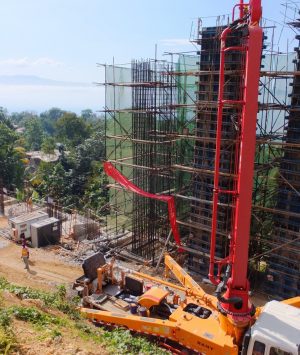 A crane is in the foreground of a construction site.