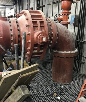 A red pipe sitting in the middle of a room.