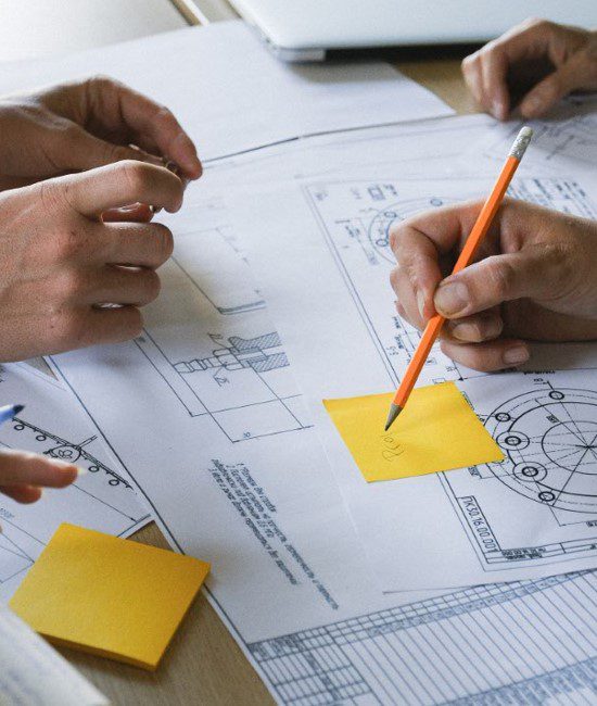 consulting-services-skyline A group of people are working on plans together.