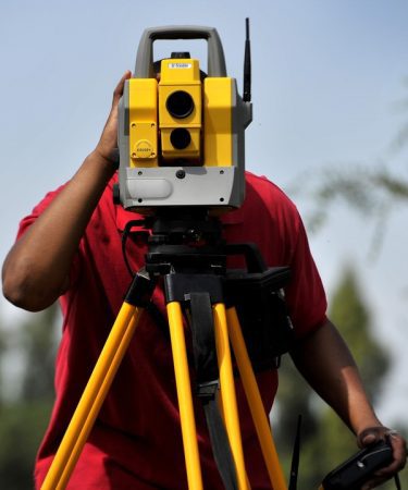 A man is holding up a yellow and black device