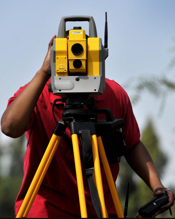 A man is using a surveying instrument to survey.