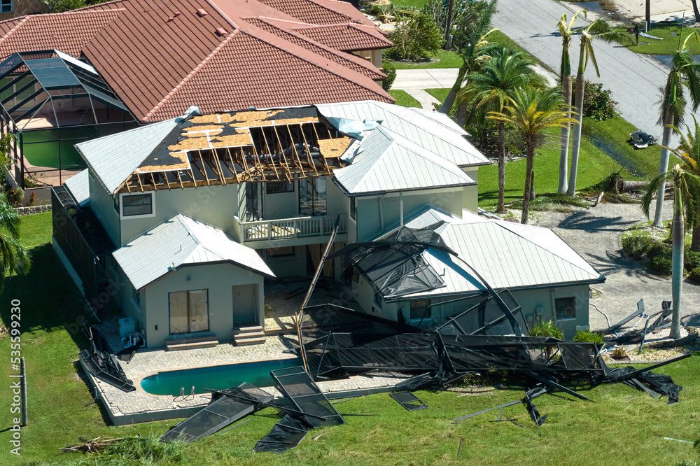 House with roof and pool damage. House with roof and pool damage.